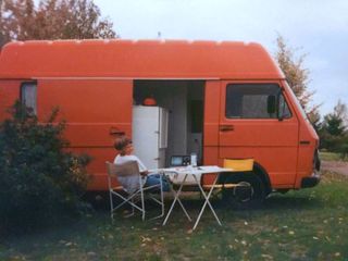 Vanever founder in front of old camper van